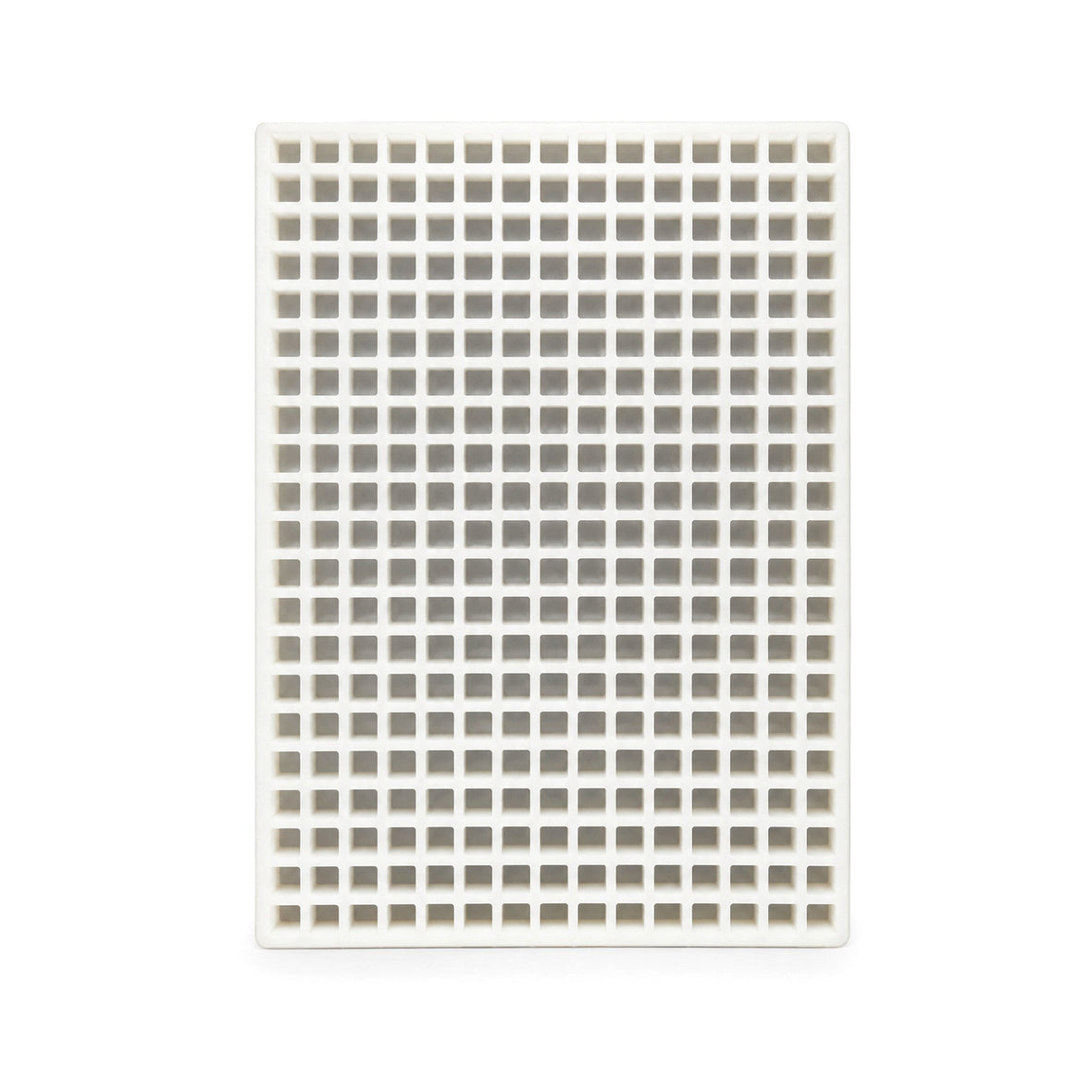 Top view of a commercial silicone candy mold with many square cavities