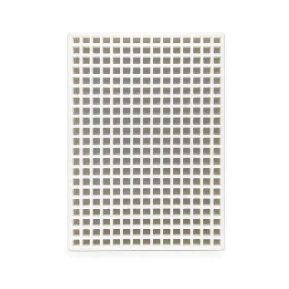 Top view of a commercial silicone candy mold with many square cavities
