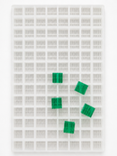 7.5mL 10-piece square breaker gummy mold with 104 cavities and emerald green segmented gummies on a white background